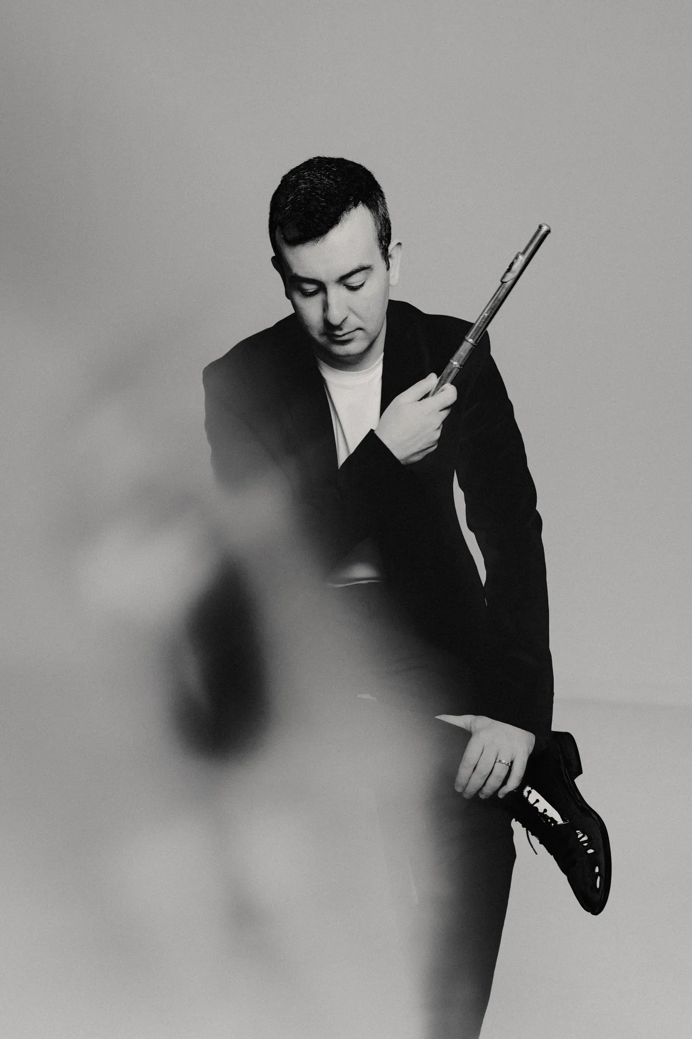 Black and white portrait of Alberto Acuña holding his flute