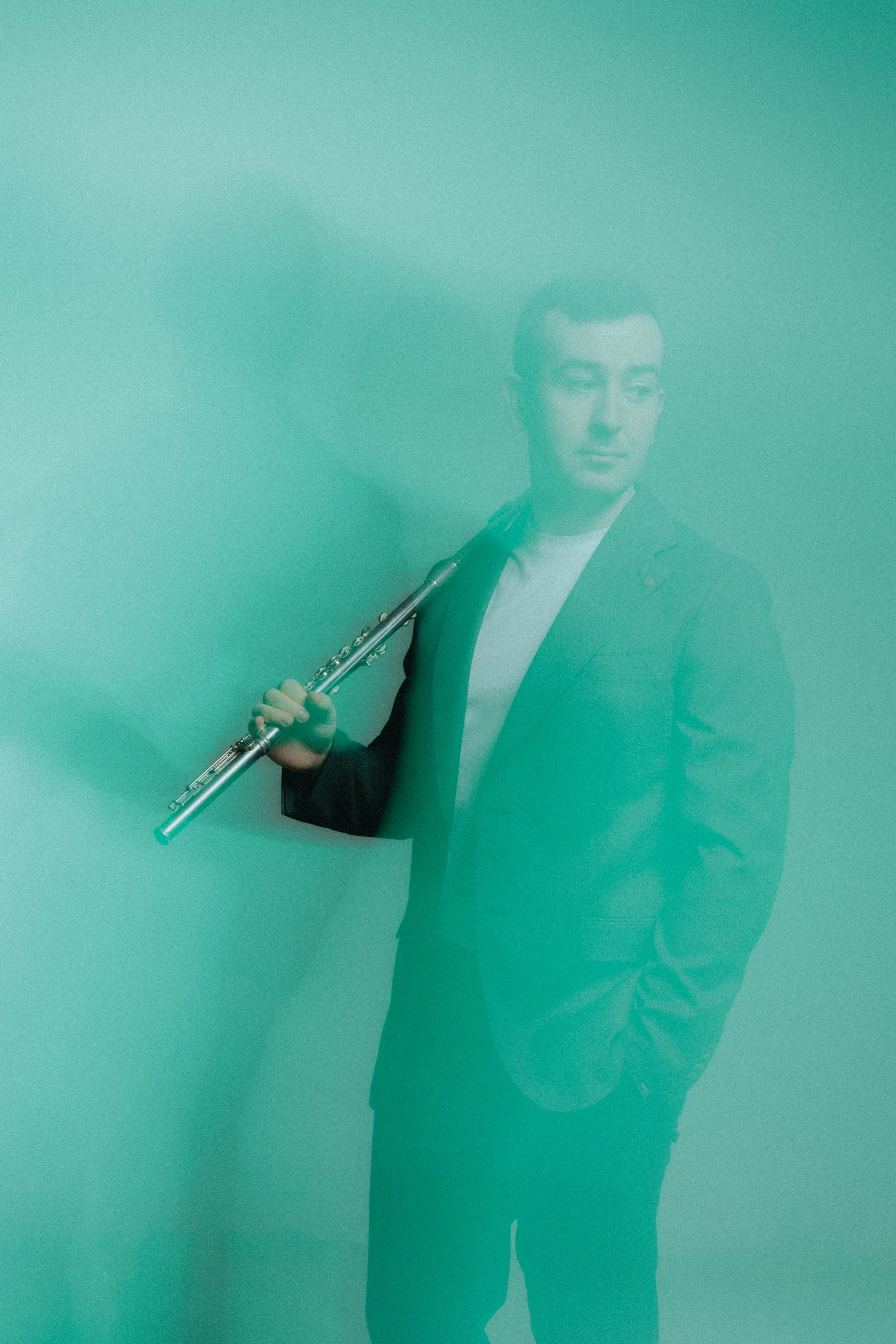 Alberto Acuña seen through green haze, flute over his shoulder